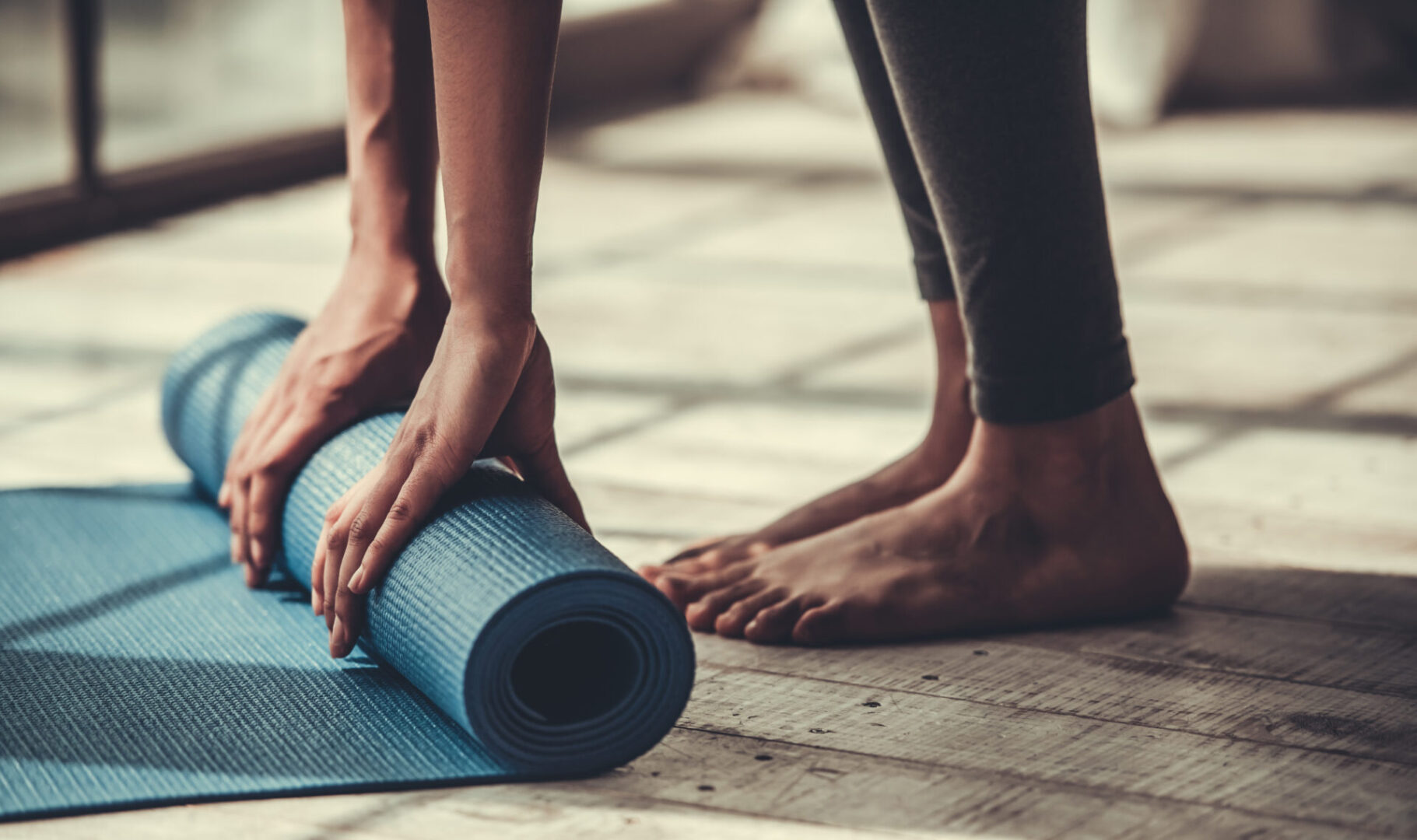 Cropped,Image,Of,Afro,American,Rolling,Yoga,Mat